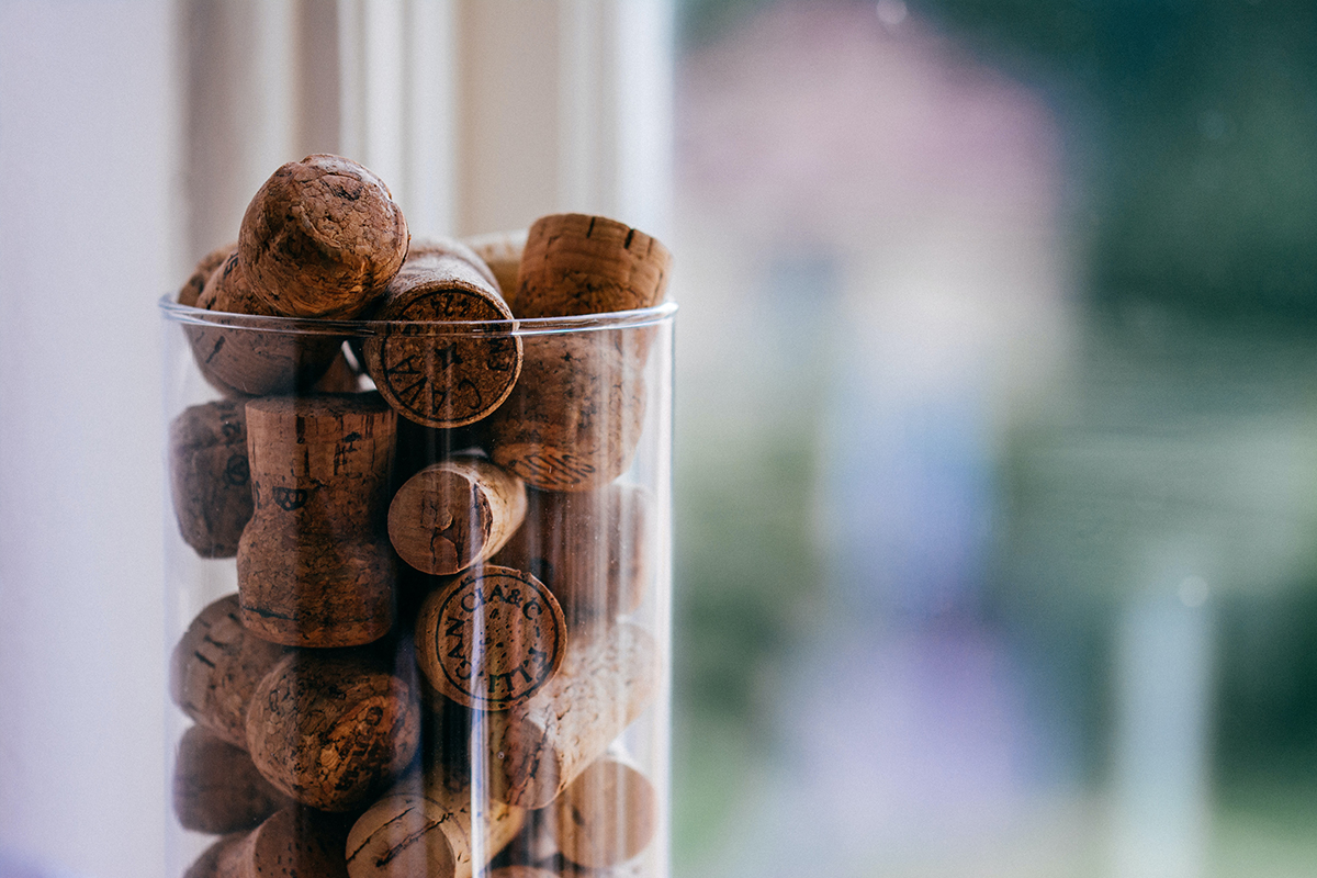 Wine corks in a glass jar as a vacation rental guest book idea.