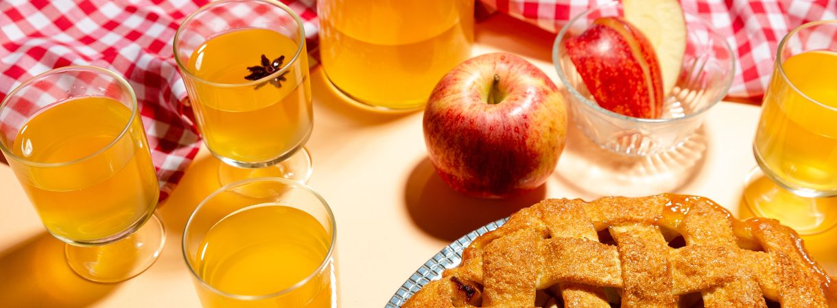 Apple pie and glasses of apple cider