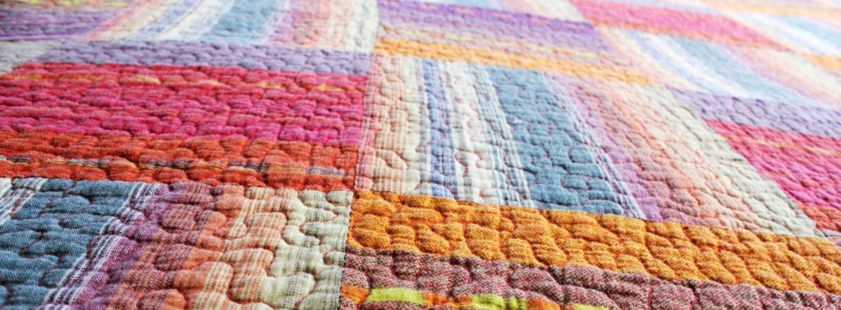 Patchwork quilt with vibrant colors.